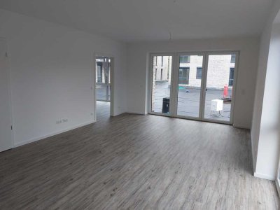 Neubau: Exklusive 4-Zi.-EG-Whg. (ca. 106,71 m²) mit EBK + Terrasse + TG-Stellplatz in zentraler Lage